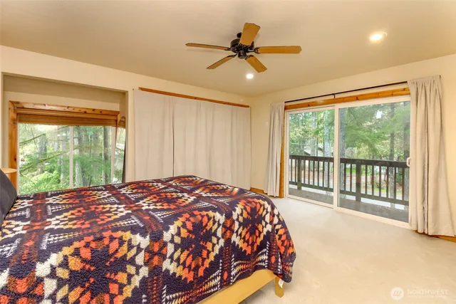 a bed sitting in a spacious bedroom next to a window