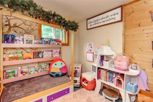 a bedroom with toys and a book shelf