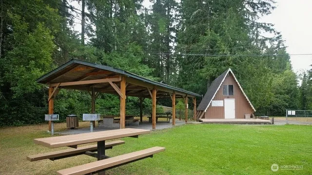 a view of backyard with deck and garden