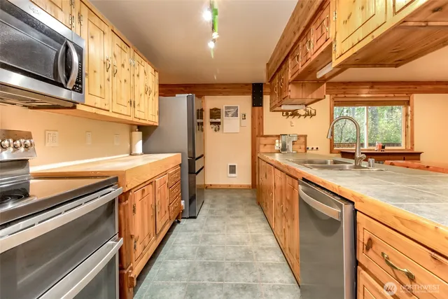 a kitchen with stainless steel appliances a sink and cabinets