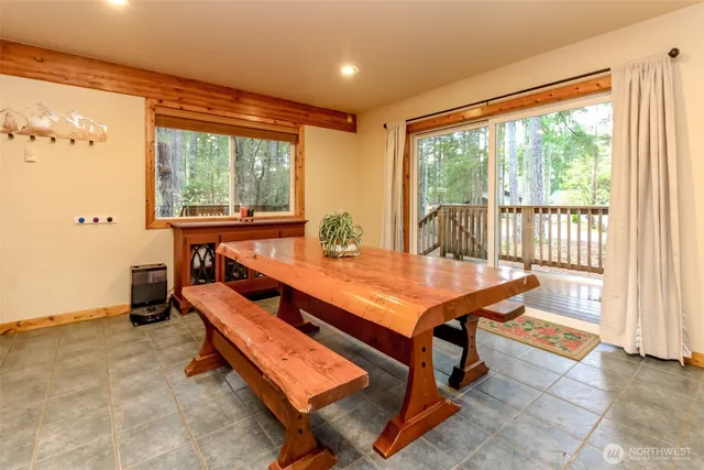 a room with pool table and windows