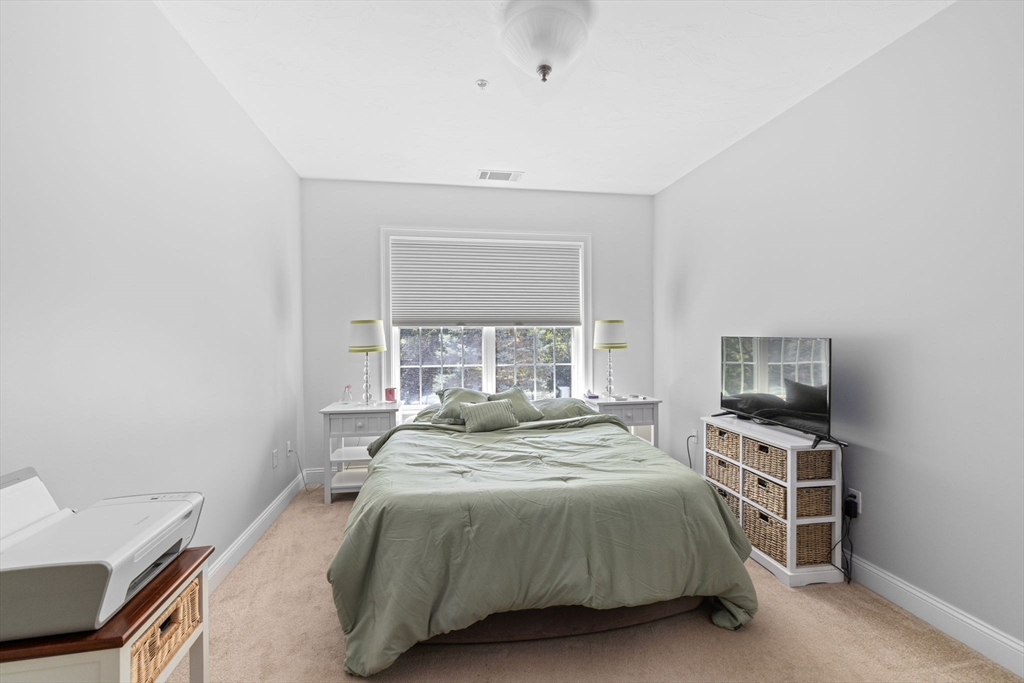 2204 Davenport Avenue, Unit 2204 Canton, MA 02021 - Photo 13 of 28 a bedroom with a bed and a window