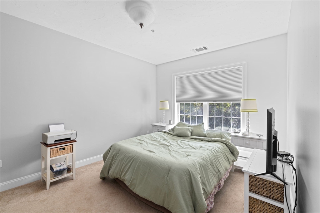 2204 Davenport Avenue, Unit 2204 Canton, MA 02021 - Photo 14 of 28 a bedroom with a bed and a window