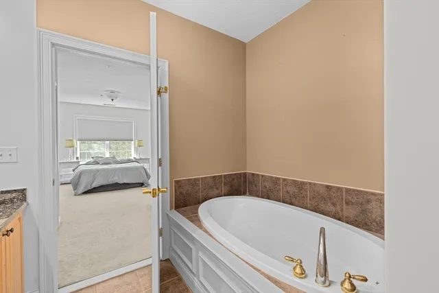 a bathroom with a tub and a sink