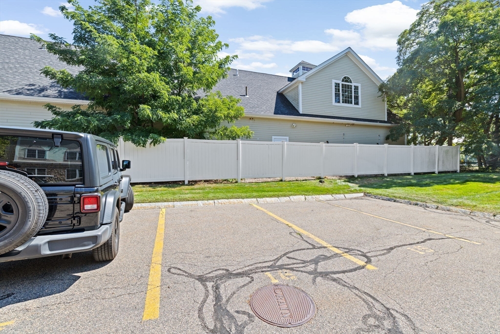 2204 Davenport Avenue, Unit 2204 Canton, MA 02021 - Photo 24 of 28 a view of a backyard with table and chairs under an umbrella