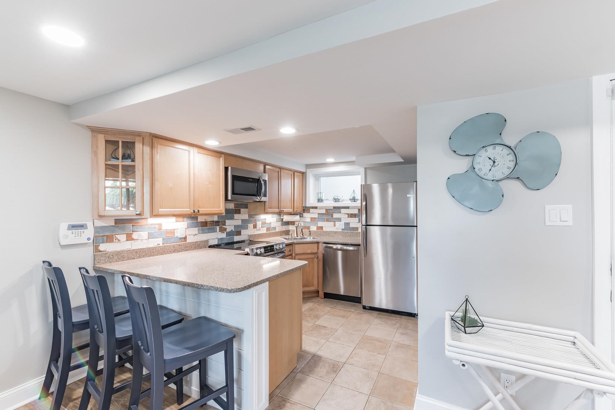 15 99th Street, Unit A Stone Harbor, NJ 08247 - Photo 17 of 41 a kitchen with a dining table chairs and refrigerator