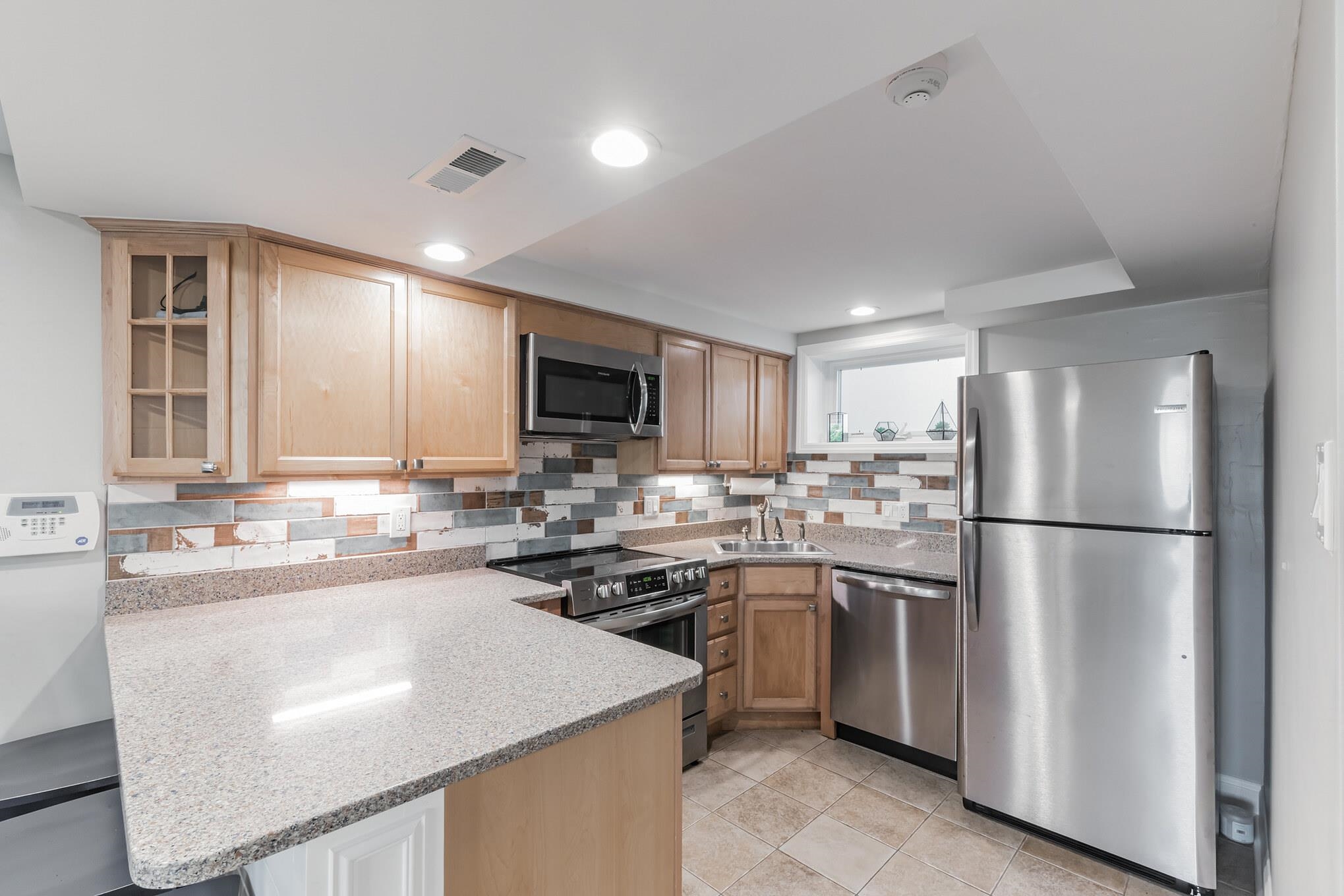 15 99th Street, Unit A Stone Harbor, NJ 08247 - Photo 18 of 41 a kitchen with a sink a refrigerator and a stove top oven
