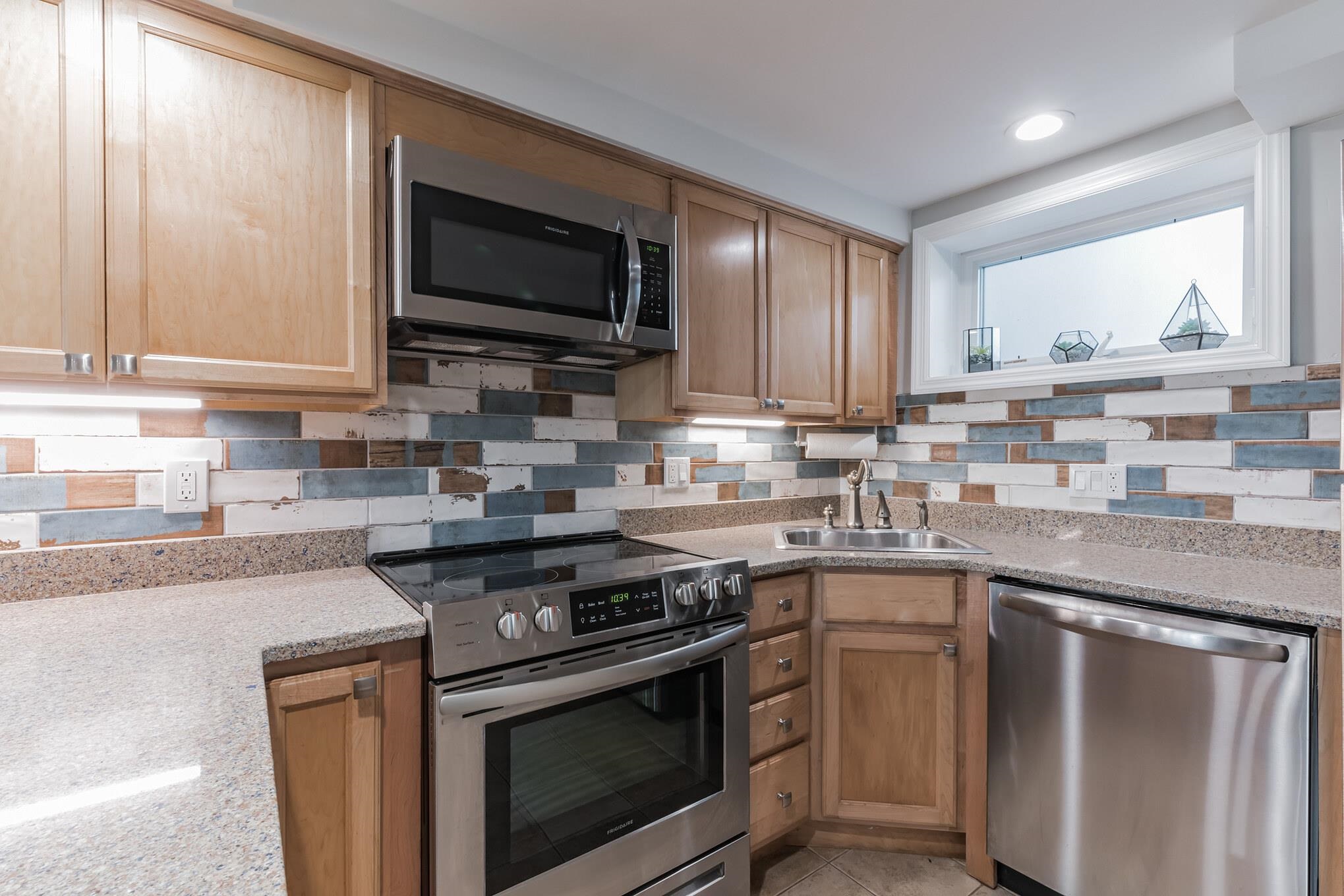 15 99th Street, Unit A Stone Harbor, NJ 08247 - Photo 21 of 41 a kitchen with stainless steel appliances granite countertop a stove a sink and a microwave