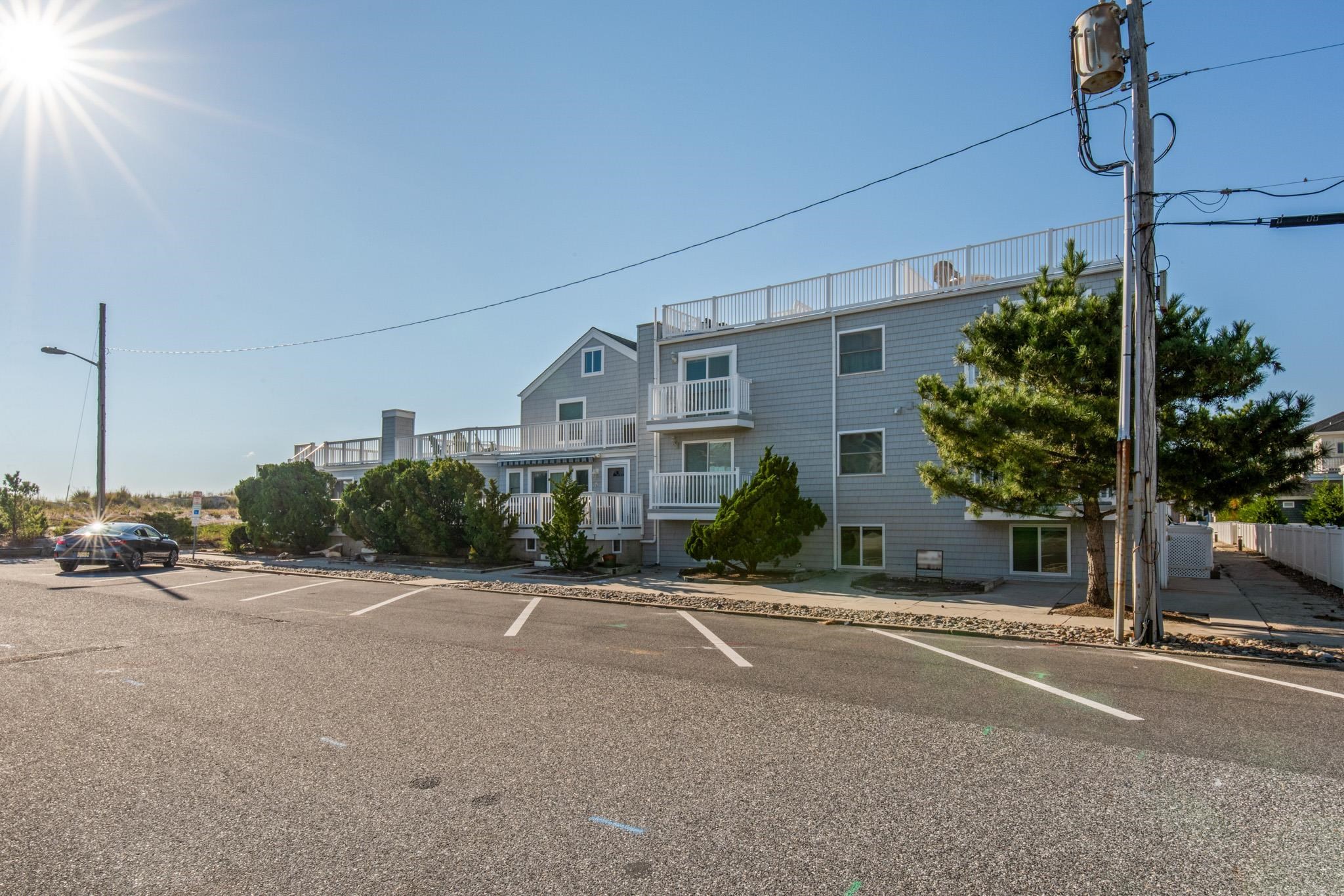 15 99th Street, Unit A Stone Harbor, NJ 08247 - Photo 3 of 41 a front view of a house with a yard and a garage