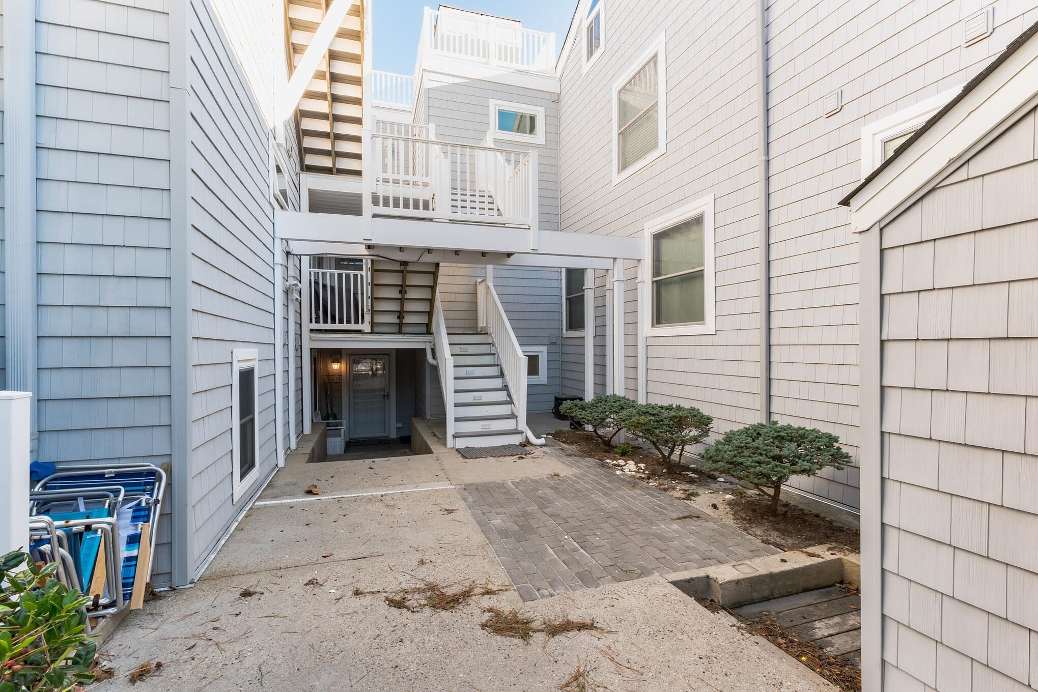 15 99th Street, Unit A Stone Harbor, NJ 08247 - Photo 8 of 41 a front view of a house with a garage