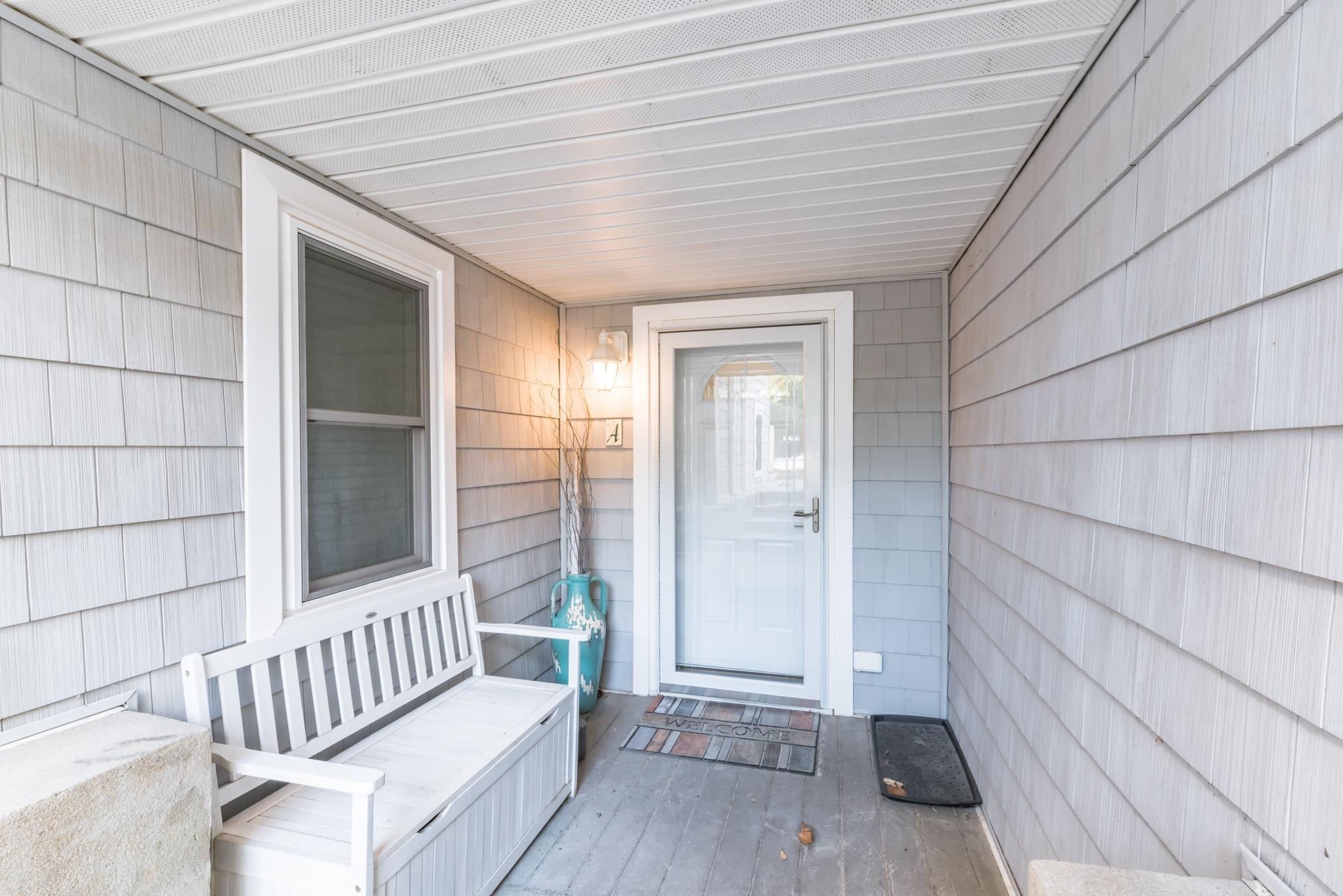 15 99th Street, Unit A Stone Harbor, NJ 08247 - Photo 9 of 41 a view of a porch with wooden floor and a glass door