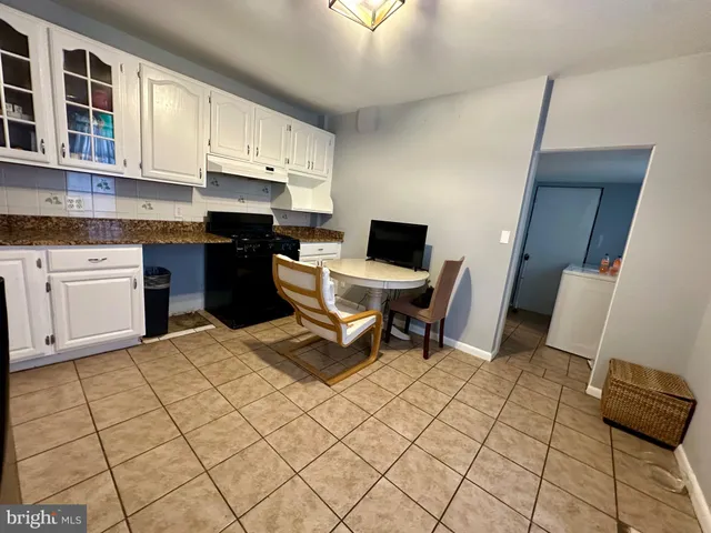 a kitchen with a sink and a stove top oven