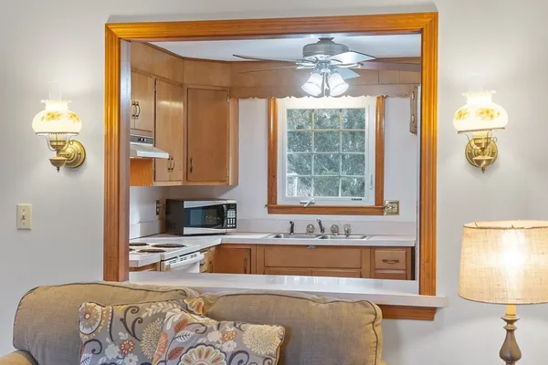 a spacious bedroom with a bed and a chandelier
