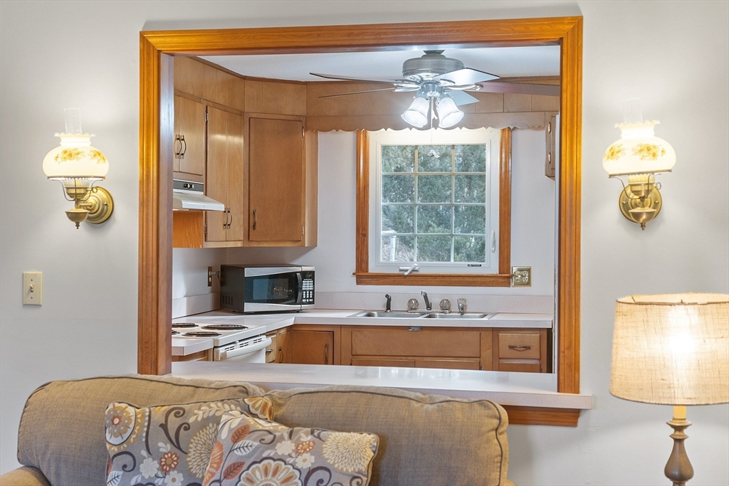 46 Woodruff Road Clinton, MA 01510 - Photo 14 of 38 a spacious bedroom with a bed and a chandelier