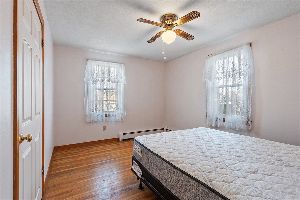 46 Woodruff Road Clinton, MA 01510 - Photo 19 of 38 a bedroom with a large bed and a window