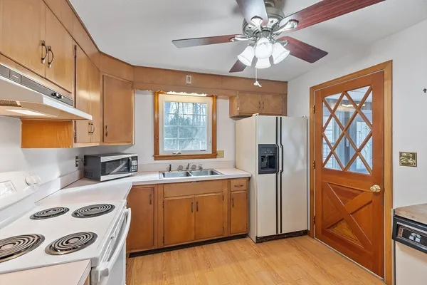 a kitchen with a stove a sink and a refrigerator