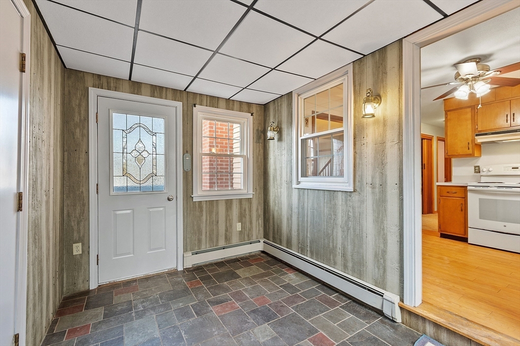 46 Woodruff Road Clinton, MA 01510 - Photo 9 of 38 a view of a hallway with wooden floor and a kitchen