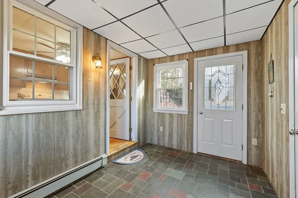 a view of a hallway with wooden floor and a cabinet