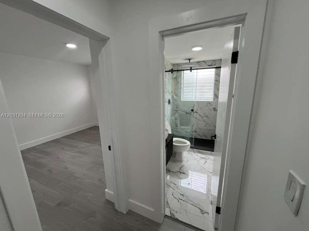 316 Surfside Boulevard, Unit 2 Surfside, FL 33154 - Photo 9 of 13 an empty room with an entrance to other room