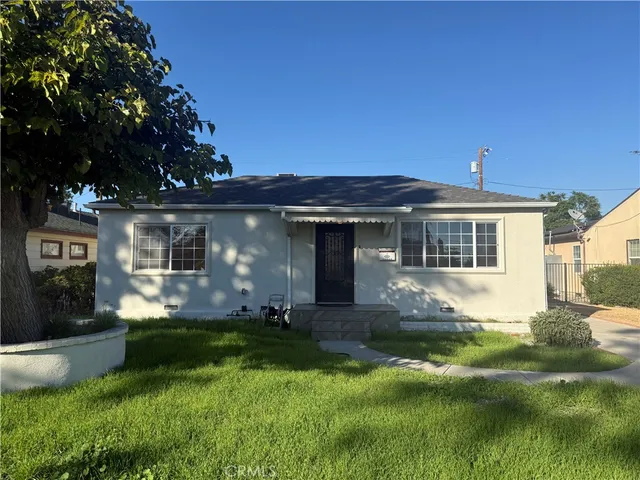 a front view of a house with a yard and porch