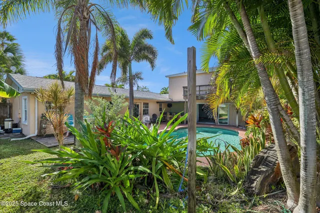 an aerial view of a house with swimming pool patio and outdoor seating