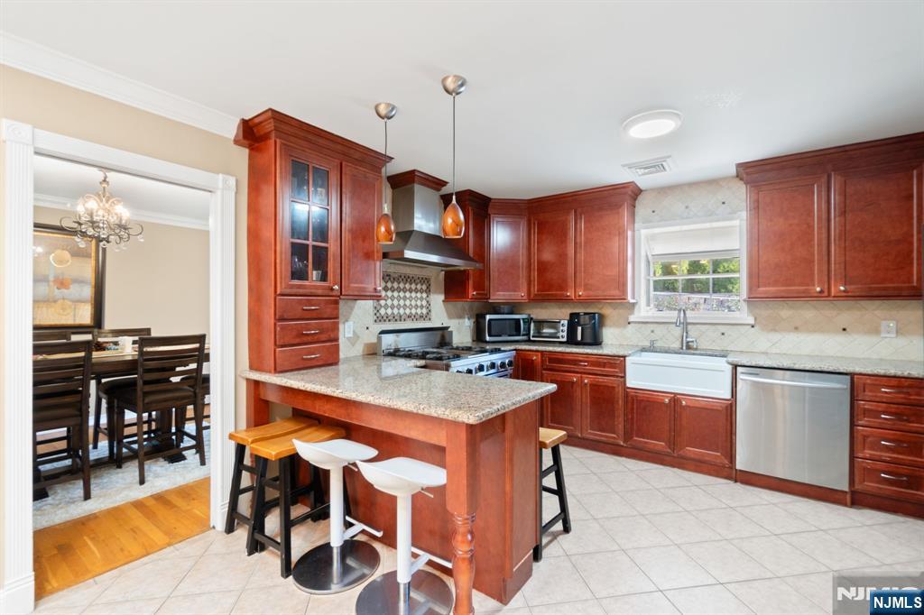 51 Anderson Avenue Englewood Cliffs, NJ 07632 - Photo 12 of 46 a kitchen with stainless steel appliances granite countertop wooden cabinets a stove top oven a sink and dishwasher