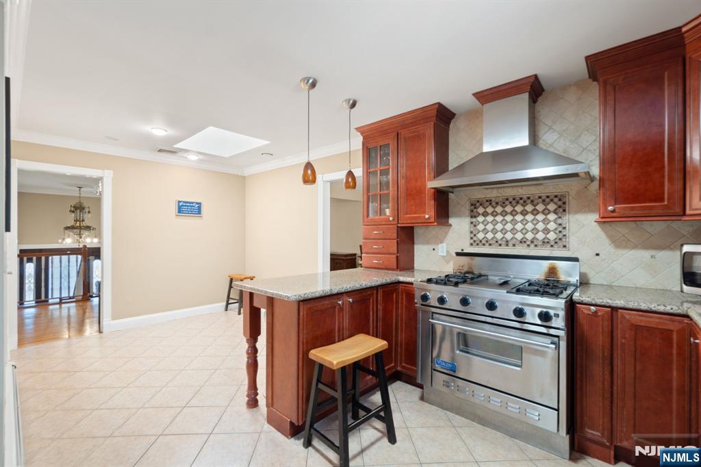 51 Anderson Avenue Englewood Cliffs, NJ 07632 - Photo 14 of 46 a kitchen with stainless steel appliances a stove a refrigerator and wooden cabinets