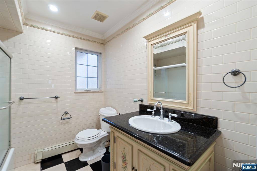 51 Anderson Avenue Englewood Cliffs, NJ 07632 - Photo 17 of 46 a bathroom with a sink a toilet and a mirror