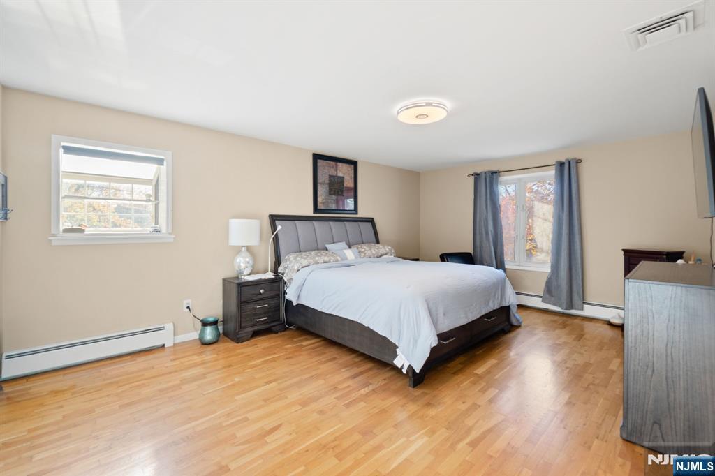 51 Anderson Avenue Englewood Cliffs, NJ 07632 - Photo 20 of 46 a bedroom with a bed and wooden floor