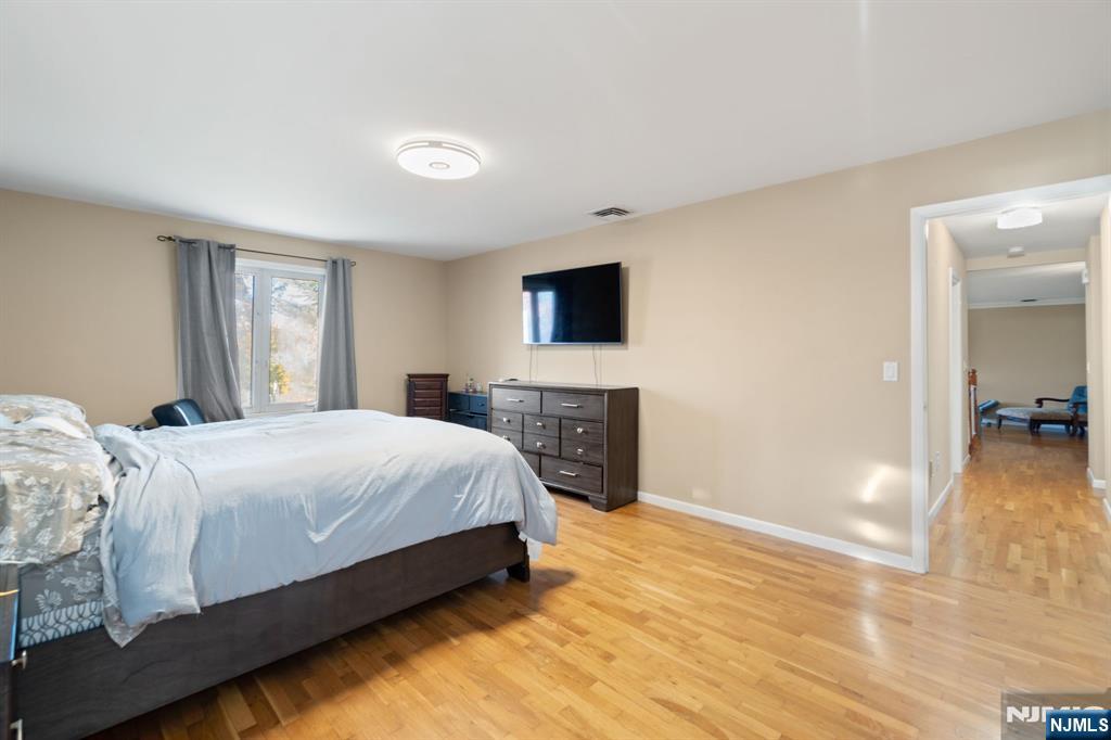 51 Anderson Avenue Englewood Cliffs, NJ 07632 - Photo 21 of 46 a spacious bedroom with a bed and a flat screen tv