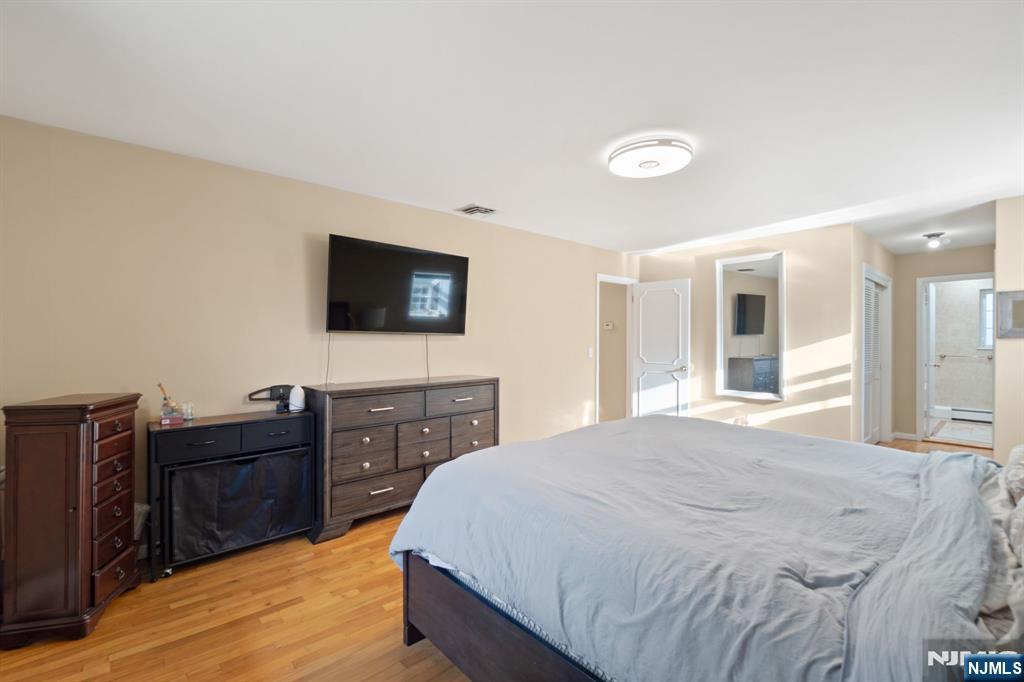 51 Anderson Avenue Englewood Cliffs, NJ 07632 - Photo 22 of 46 a bedroom with a bed and a flat screen tv