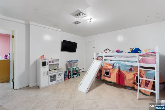 a bedroom with furniture and a flat screen tv