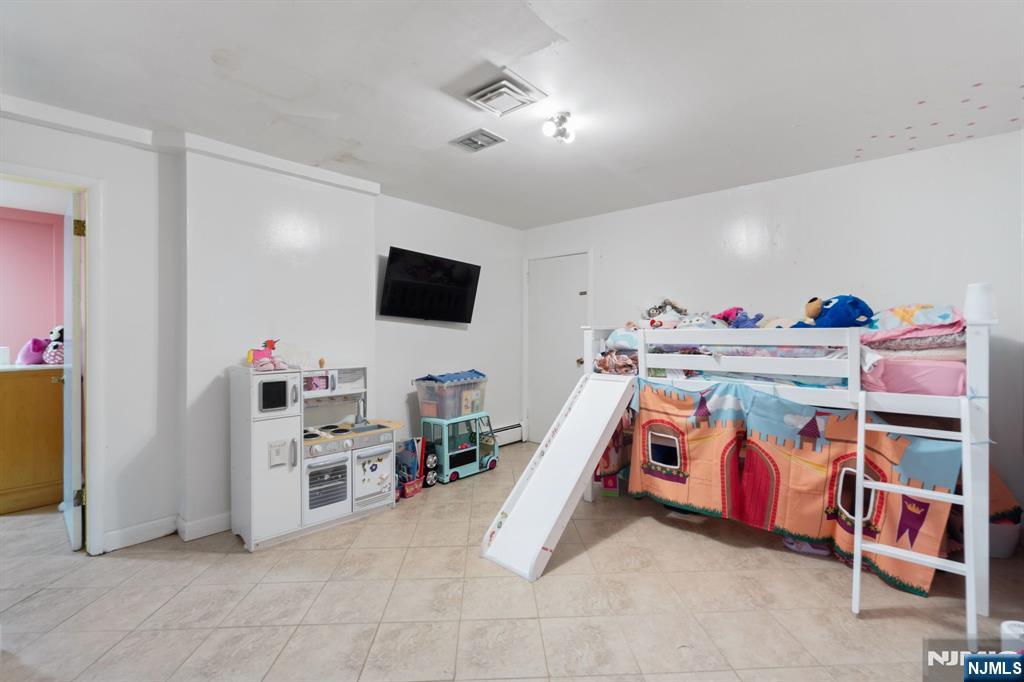 51 Anderson Avenue Englewood Cliffs, NJ 07632 - Photo 28 of 46 a bedroom with furniture and a flat screen tv