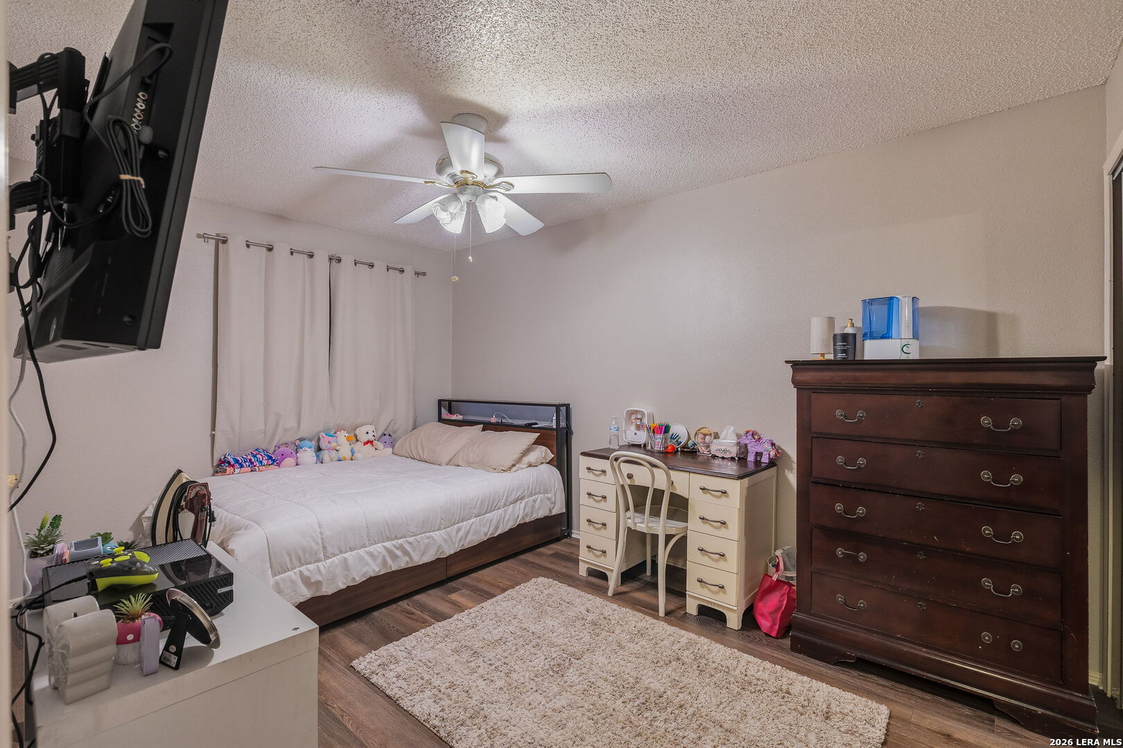 9140 Timber Path, Unit 2502 San Antonio, TX 78250 - Photo 12 of 26 a bedroom with a bed and a chandelier