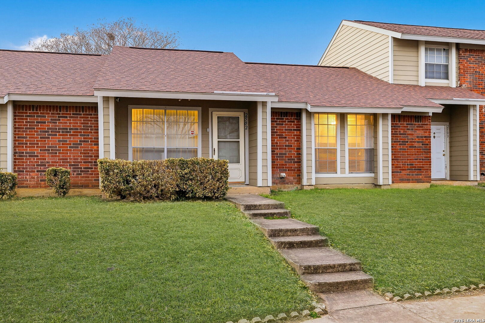 9140 Timber Path, Unit 2502 San Antonio, TX 78250 - Photo 2 of 26 a front view of a house with a garden