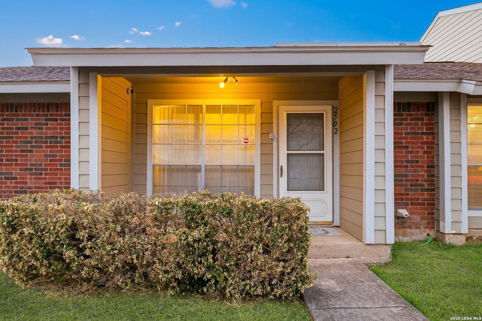 9140 Timber Path, Unit 2502 San Antonio, TX 78250 - Photo 4 of 26 a front view of a house with a garden
