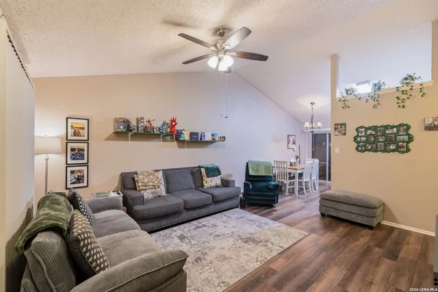 a living room with furniture and wooden floor