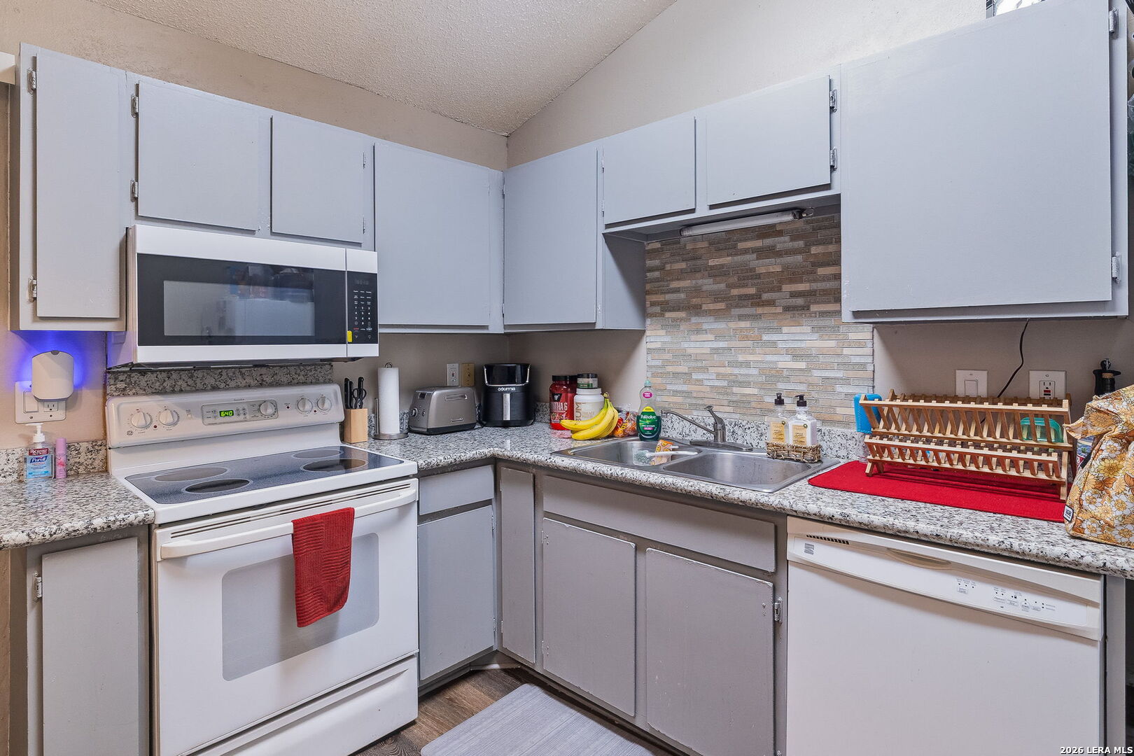 9140 Timber Path, Unit 2502 San Antonio, TX 78250 - Photo 10 of 26 a kitchen with stainless steel appliances granite countertop a sink and cabinets