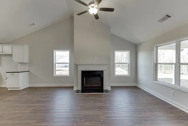 a living room with fireplace and wooden floor