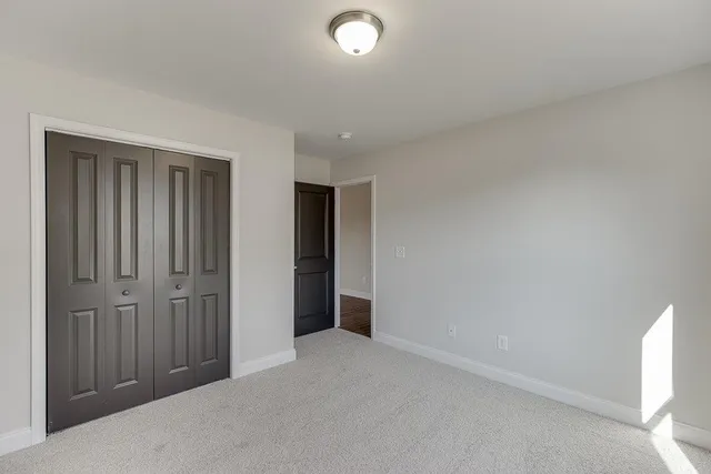 an empty room with closet area