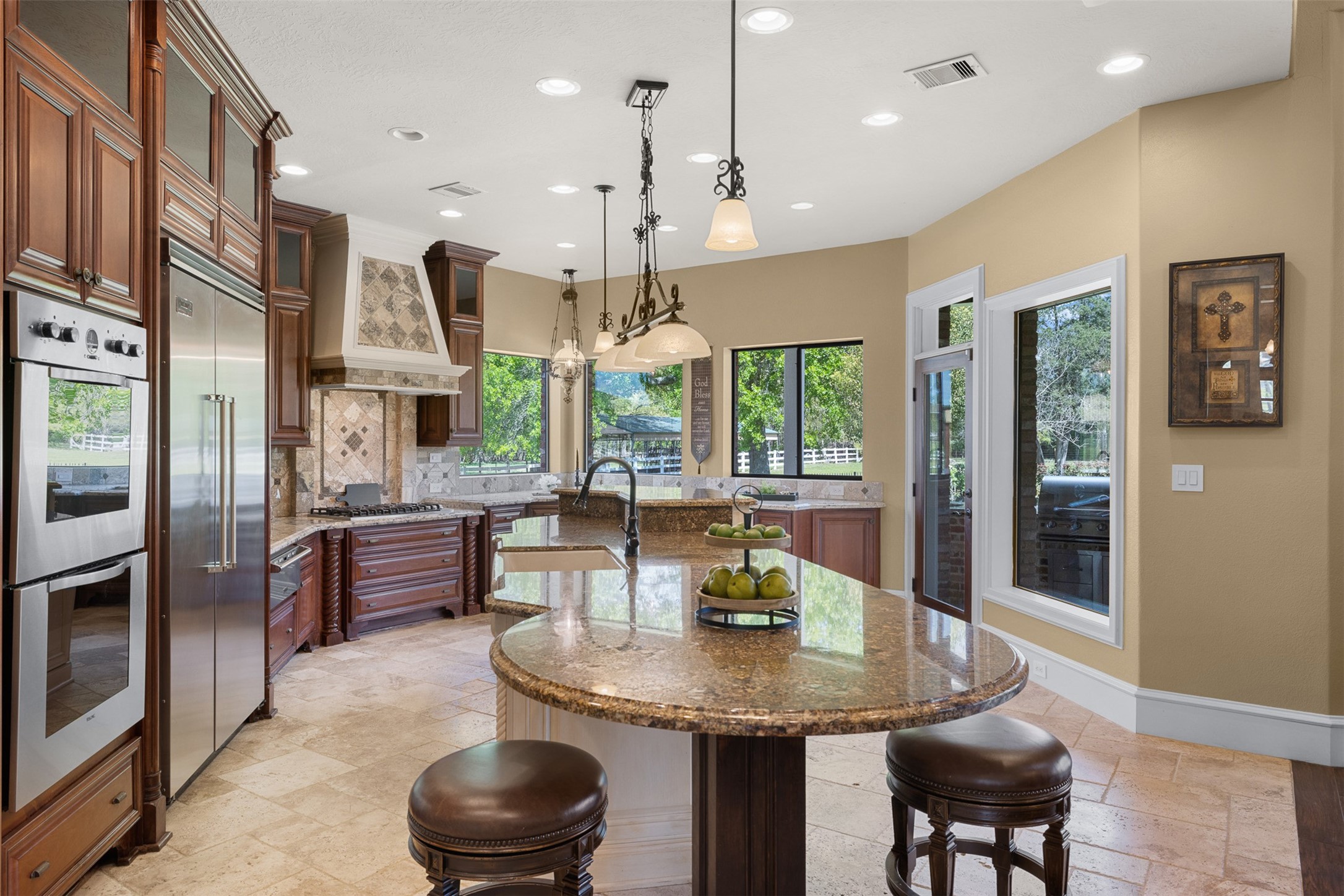 29500 Skymac Ranch Road Hempstead, TX 77445 - Photo 12 of 50 a kitchen with stainless steel appliances granite countertop a stove a refrigerator a kitchen island a dining table and chairs