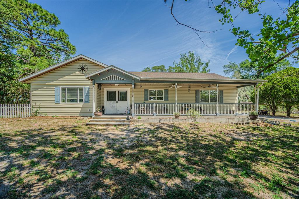 17851 Oxenham Avenue Spring Hill, FL 34610 - Photo 1 of 31 front view of a house with a garden