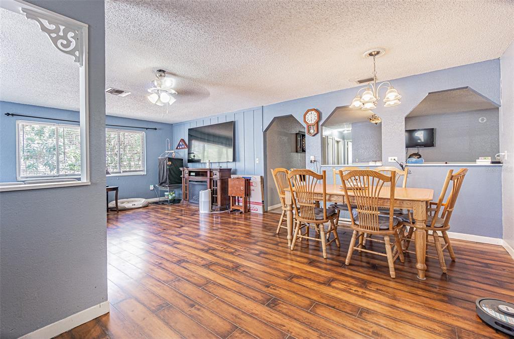 17851 Oxenham Avenue Spring Hill, FL 34610 - Photo 11 of 31 a view of a dining room with furniture window and wooden floor