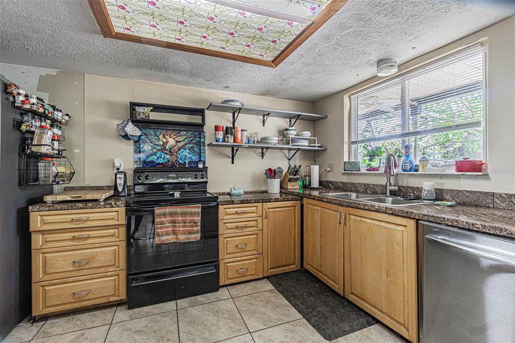17851 Oxenham Avenue Spring Hill, FL 34610 - Photo 14 of 31 a kitchen with stainless steel appliances granite countertop a sink and cabinets