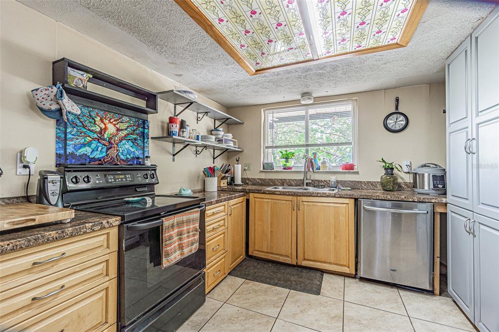 17851 Oxenham Avenue Spring Hill, FL 34610 - Photo 15 of 31 a kitchen with stainless steel appliances granite countertop a stove and cabinets
