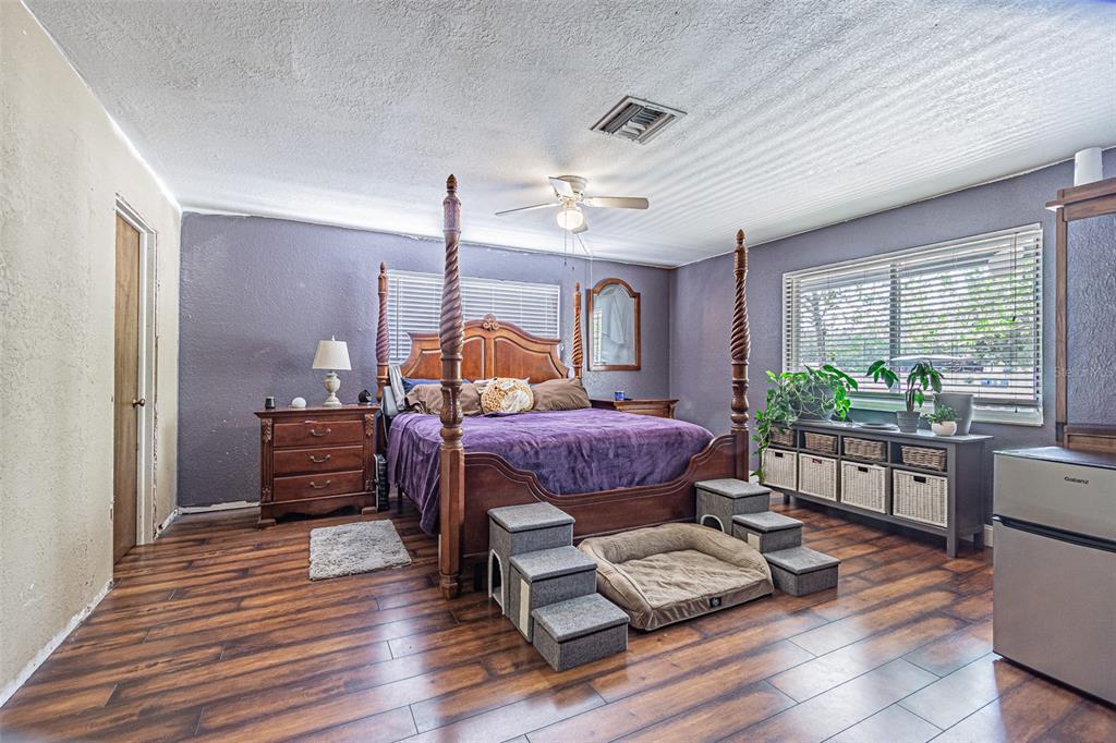 17851 Oxenham Avenue Spring Hill, FL 34610 - Photo 16 of 31 a bedroom with furniture and wooden floor