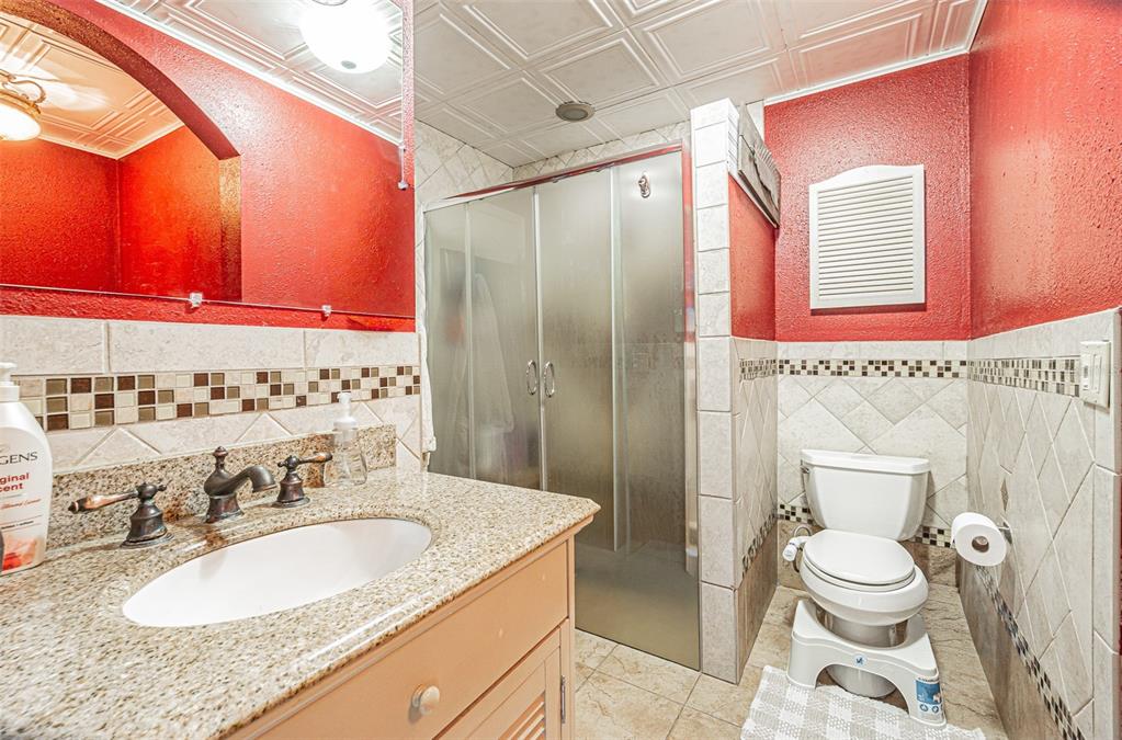 17851 Oxenham Avenue Spring Hill, FL 34610 - Photo 19 of 31 a bathroom with a granite countertop sink and a mirror
