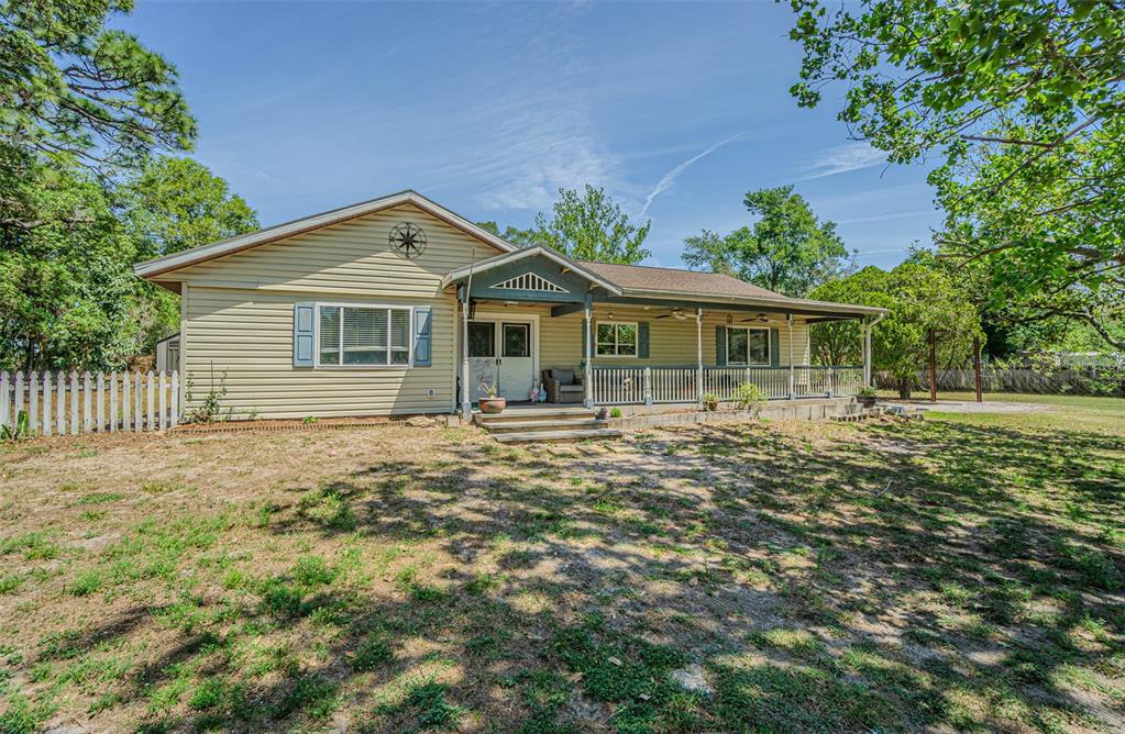 17851 Oxenham Avenue Spring Hill, FL 34610 - Photo 2 of 31 a front view of a house with a garden
