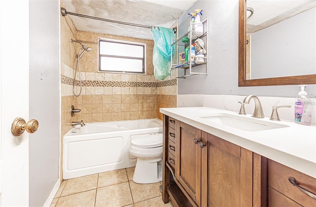 17851 Oxenham Avenue Spring Hill, FL 34610 - Photo 23 of 31 a bathroom with a sink a toilet and bathtub