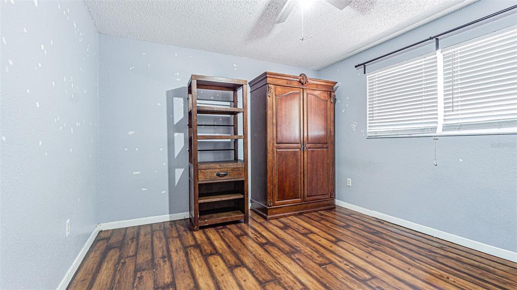 17851 Oxenham Avenue Spring Hill, FL 34610 - Photo 24 of 31 an empty room with wooden floor closet and windows